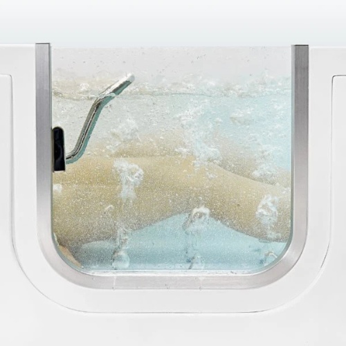 View through walk-in tub door showing bubbling hydrotherapy jets