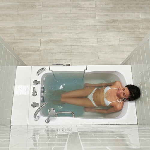 Woman reclining in a lay-down style walk-in bathtub