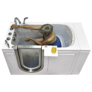 Elderly woman bathing in a walk-in tub with stainless steel door and mounted controls