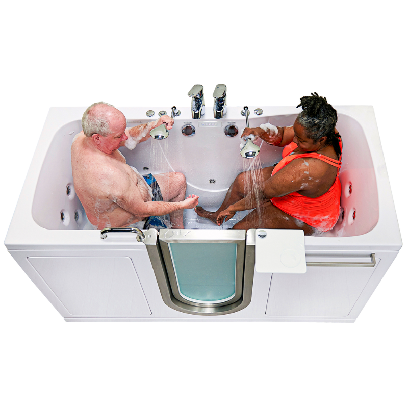Two seniors bathing together in a two-seat walk-in tub with handheld showerheads