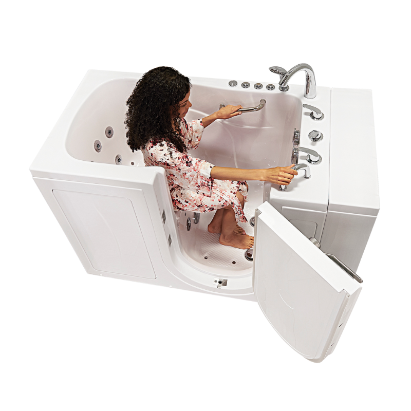 Woman adjusting controls in a walk-in tub with inward swing door